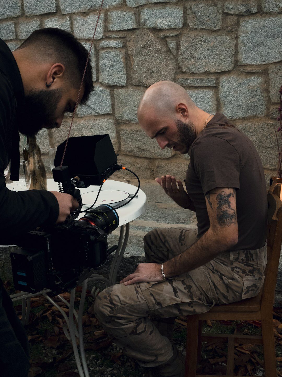 Camera operator filming with a professional broadcast camera on a studio floor