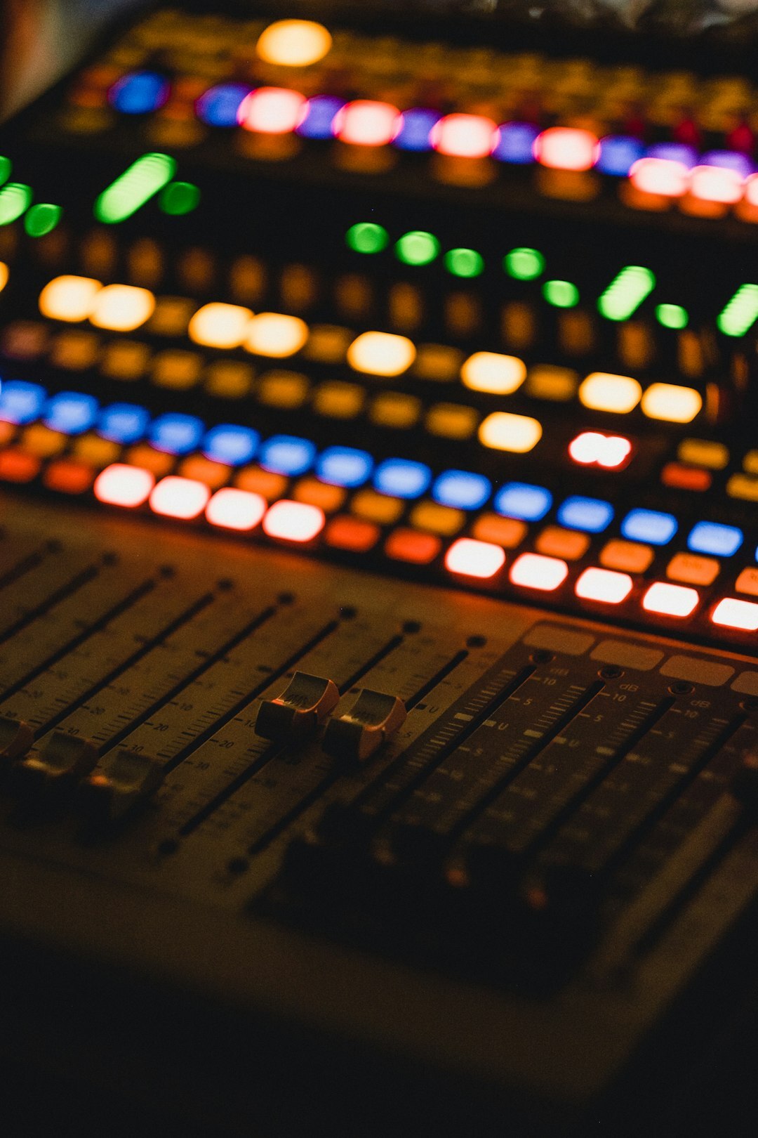 Audio mixing console with sliders used in a live broadcast