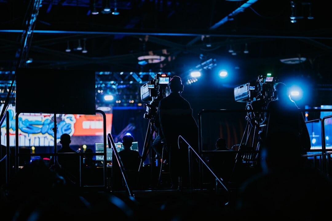 Sports broadcast control room during a live match with multiple screens