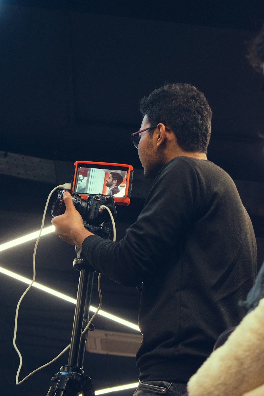 Trainer demonstrating a multi-camera switch on a live production console